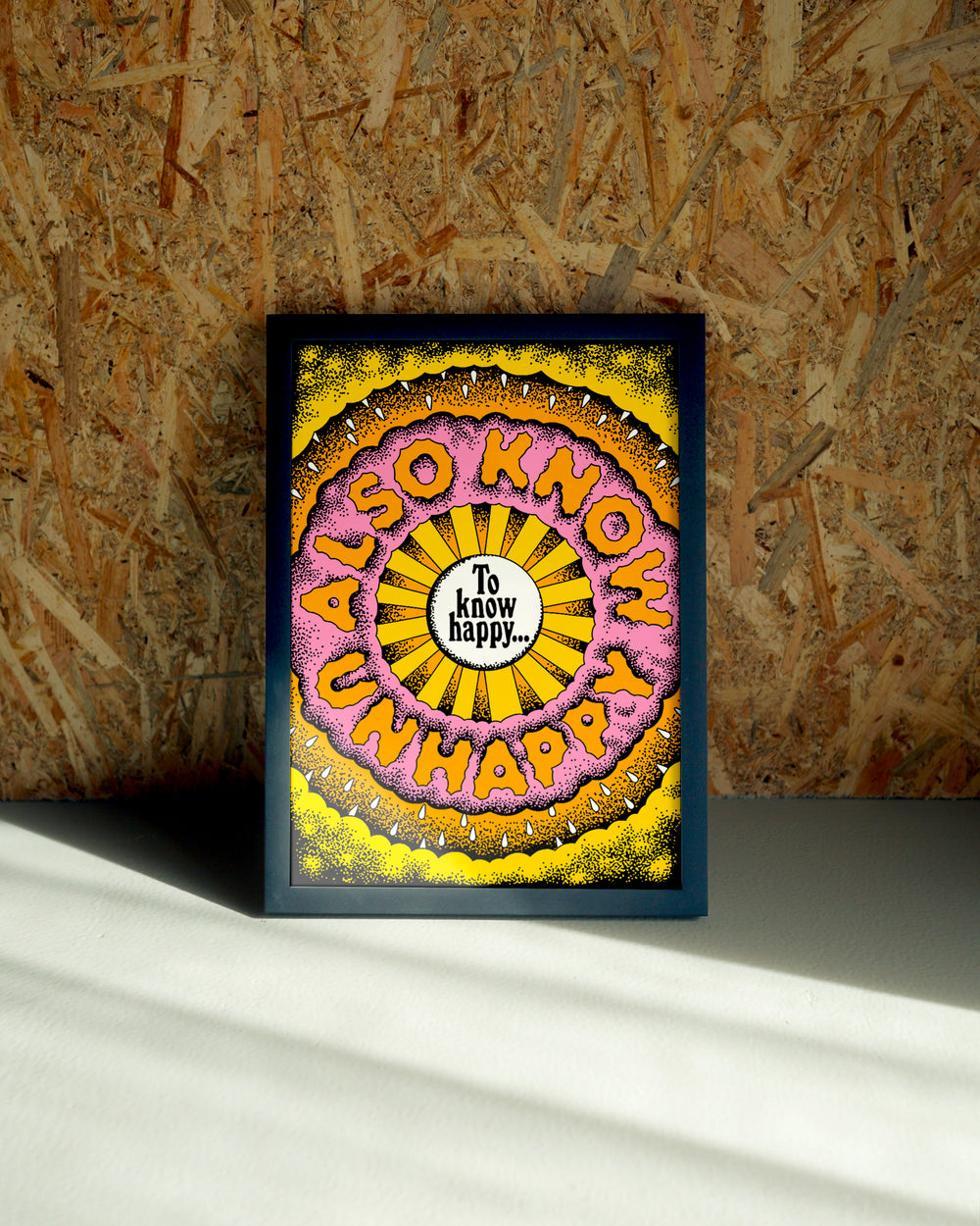 Happy wall art by Jake Foreman in a black frame